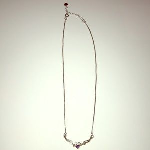 Silver tone, heart and wings necklace.